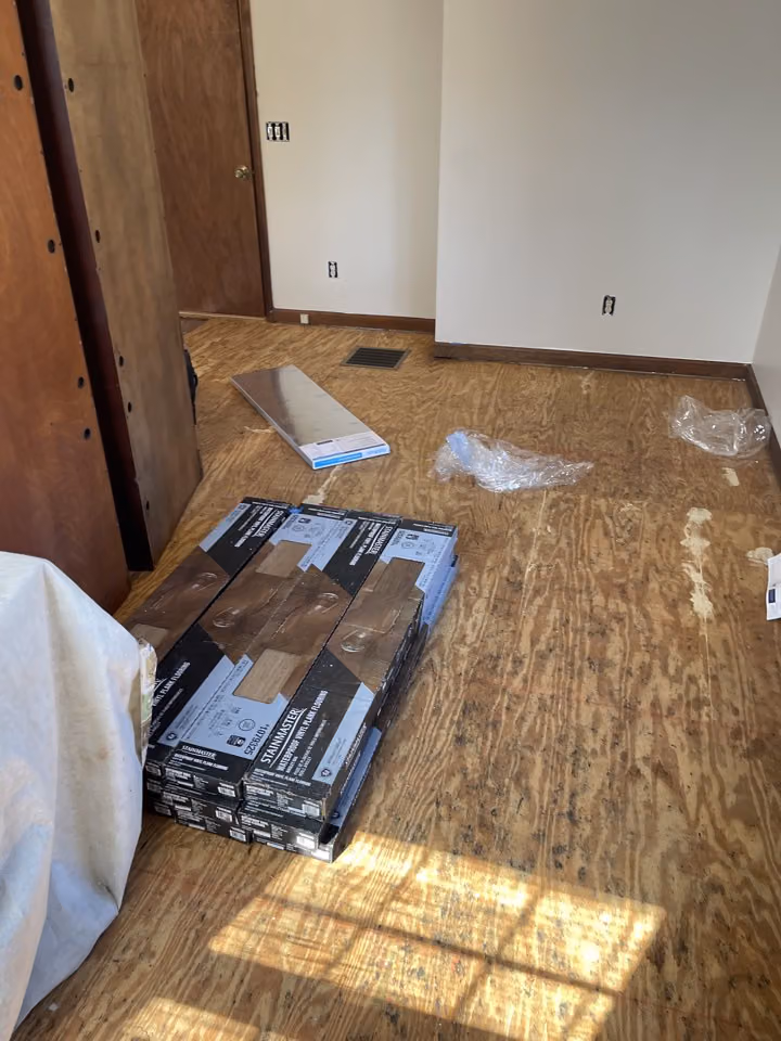 Exposed subfloor and flooring materials during the Walnut Cove project.