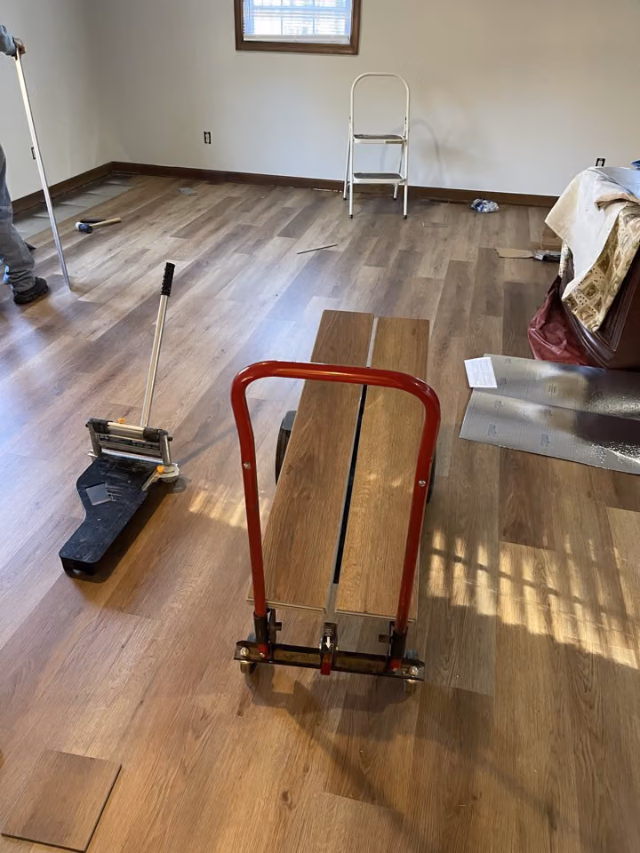 Flooring work in progress in an adjoining room.