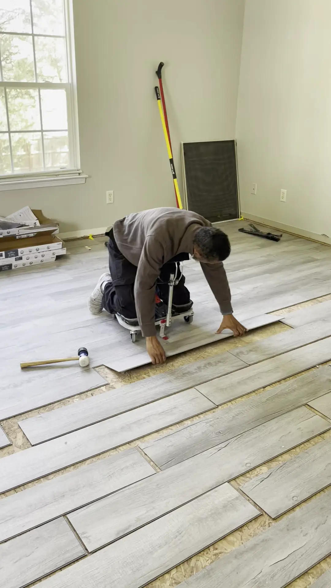 Professional luxury vinyl plank installation in progress: careful plank layout and stagger pattern installation.