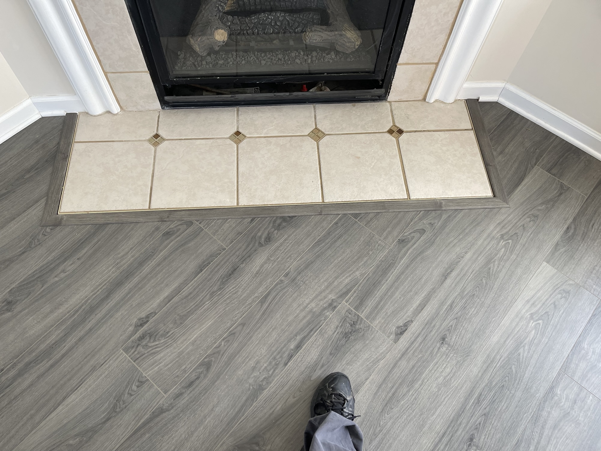 Clean picture-frame transition molding around the fireplace
